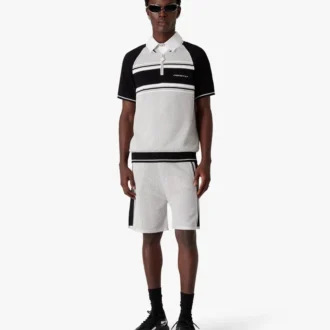 Kortärmad pikétröja med dragkedja och metalliska randiga mesh-detaljer på shortsen